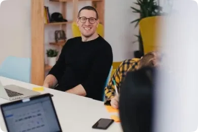 Boy with glasses and black shirt at a meeting